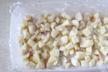 Очищенные и порезанные кубиком яблоки на креветках и заливке